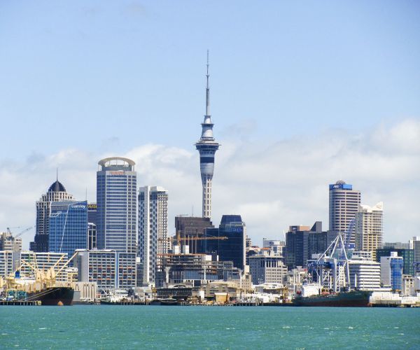 Blue water with buildings of the city of Auckland in the background