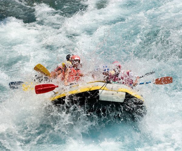 Group of people white water rafting